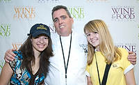 FIU-FriFoodPrep-6919 - Nativity School students Julia Adams, left, and Allison Siegel pose with FIU Professor Chef Michael Moran.while preparing for the South Beach Wine and Food Festival at the Miami Beach Convention Center kitchen.