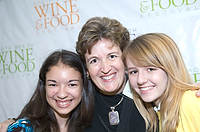 FIU-FriFoodPrep-6922 - Nativity School students Julia Adams, left, and Allison Siegel pose with Lynne Moore, center, while covering the South Beach Wine and Food Festival for their school paper in the Miami Beach Convention Center kitchen.