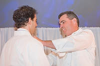 FIU-Tribute-0145 - FIU School of Hospitality Professor Chef Michael Moran, right, presents a new chefs jacket to with FIU School of Hospitality student and winner of the Barilla Best New Student Chef Award for 2008 Michael Cremeno. (Photo by Michell Zachs/FIU School of Hospitality)