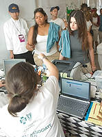 FIU-Grd-Taste-9846 - FIU School of Hospitality students Tania Arriaza, center, and Yulie Romagosa, right, are checking to work and are some of the over 500 FIU School of Hospitality students who participated at the 2008 South Beach Wine and Food Festival in Miami Beach.