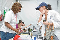 FIU-Grd-Taste-9862 - FIU School of Hospitality student Shellda Grant checks in Alina SanPedro to work and is apart of some of the over 500 FIU School of Hospitality students who participated at the 2008 South Beach Wine and Food Festival in Miami Beach.