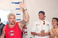 FIU-0546-WF105752 - Celebrity Chef Guy Fieri, left, congratulates FIU School of Hopitality students and staff on a job well done in the kitchen at the Grand Tasting village of the 2010 South Beach Wine and Food Festival.
