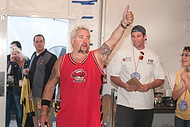 FIU-699-WF105749 - Celebrity Chef Guy Fieri, left, congratulates FIU School of Hopitality students and staff on a job well done in the kitchen at the Grand Tasting village of the 2010 South Beach Wine and Food Festival.