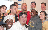 FIU-701-WF105763 - Celebrity Chef Guy Fieri, top third from right, congratulates FIU School of Hopitality students and staff on a job well done in the kitchen at the Grand Tasting village of the 2010 South Beach Wine and Food Festival.