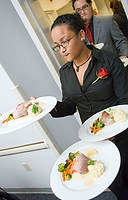 FIU-Lunch-4280 - Nikitia Couri serves guests consisting of mostly school staff and deans of FIU, in the School of Hospitality and Tourism dining room at the college's Biscayne Campus in Miami during a luncheon prepared by culinary students.
