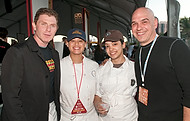 FIU-0210-WF10 - Celebrity Chefs Bobby Flay, left, and Michael Symon with FIU School of Hospitality student Kimberly Coo, 2nd from left, and restaurant worker Bibiana Montesino at the Burger Bash at the 2010 South Beach Wine & Food Festival
