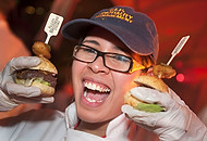 FIU-0254-WF10 - FIU School of Hospitality student volunteer Krystal Gonzalez with a db Bistro Moderne mini burgers out of New York, New York. at the Burger Bash at the 2010 South Beach Wine & Food Festival