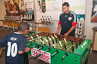 52-TMobileElPibe<br>Bryan Areiza-Miranda, left, and Steve Areiza-Miranda play T-Mobile Foosball